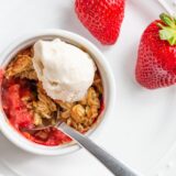 Air fryer strawberry crisp with a scoop of ice cream.