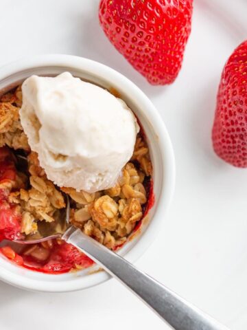 Air fryer strawberry crisp with a scoop of ice cream.