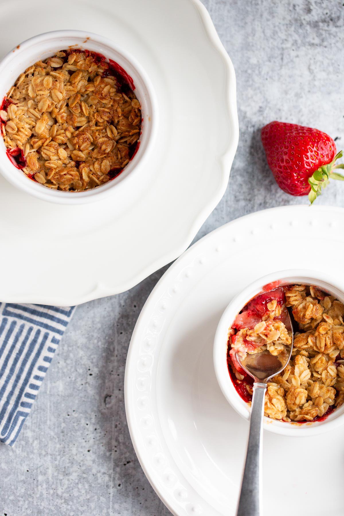 Two strawberry crisps on plates.