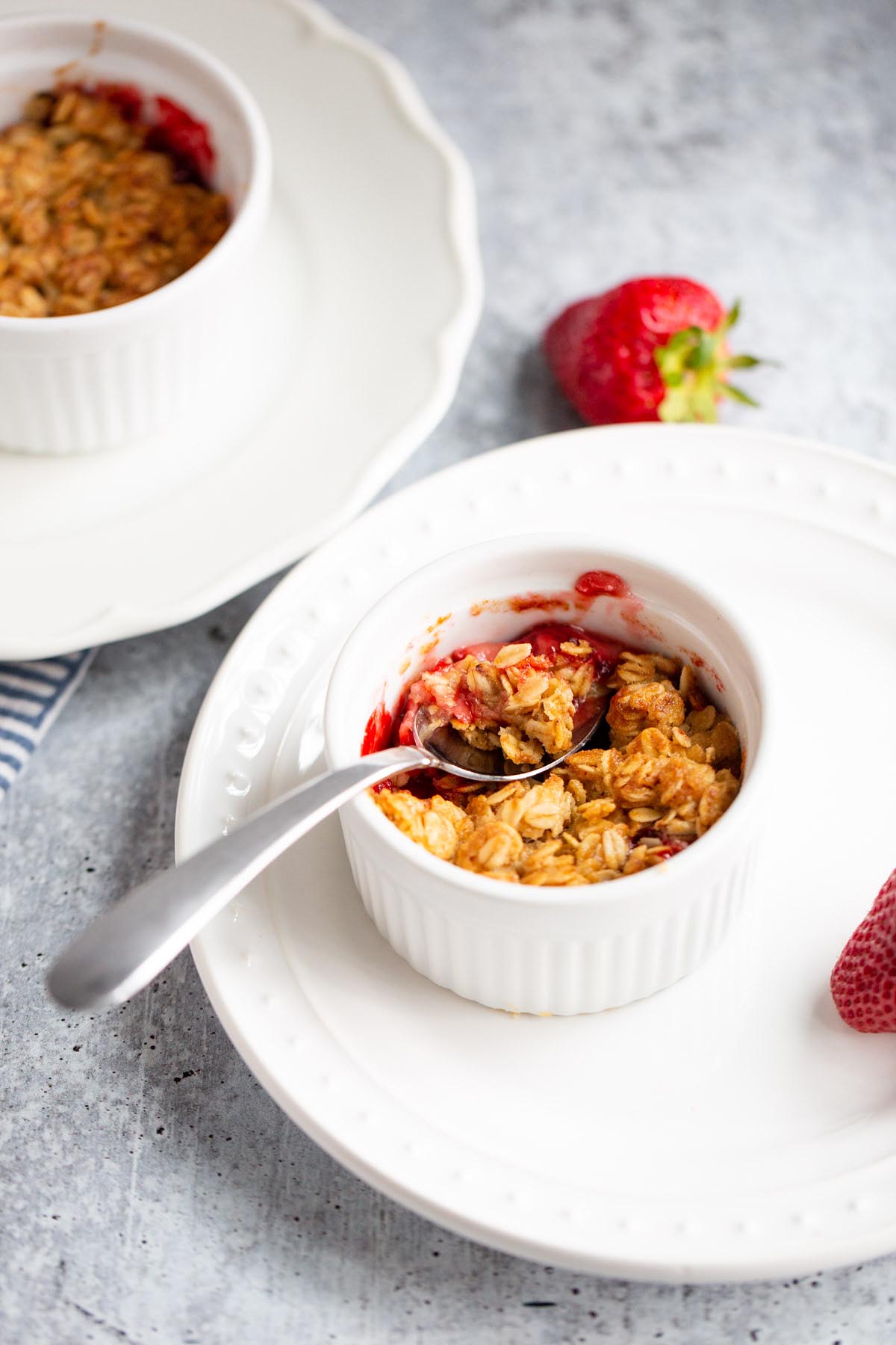 Strawberry crisp with a spoon.