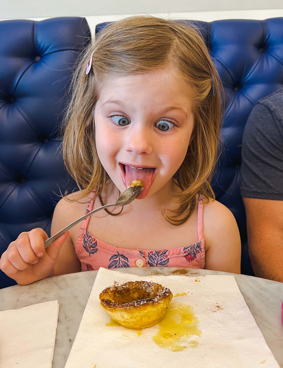 Girl eating Pastel de Nata.