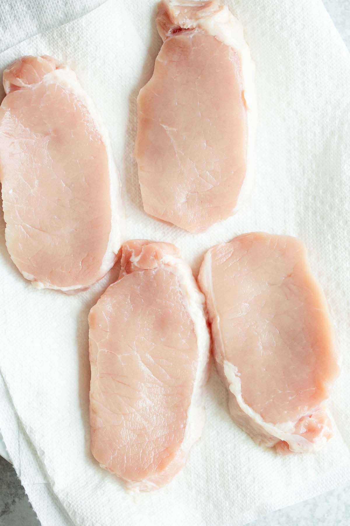 Boneless pork chops on a plate.