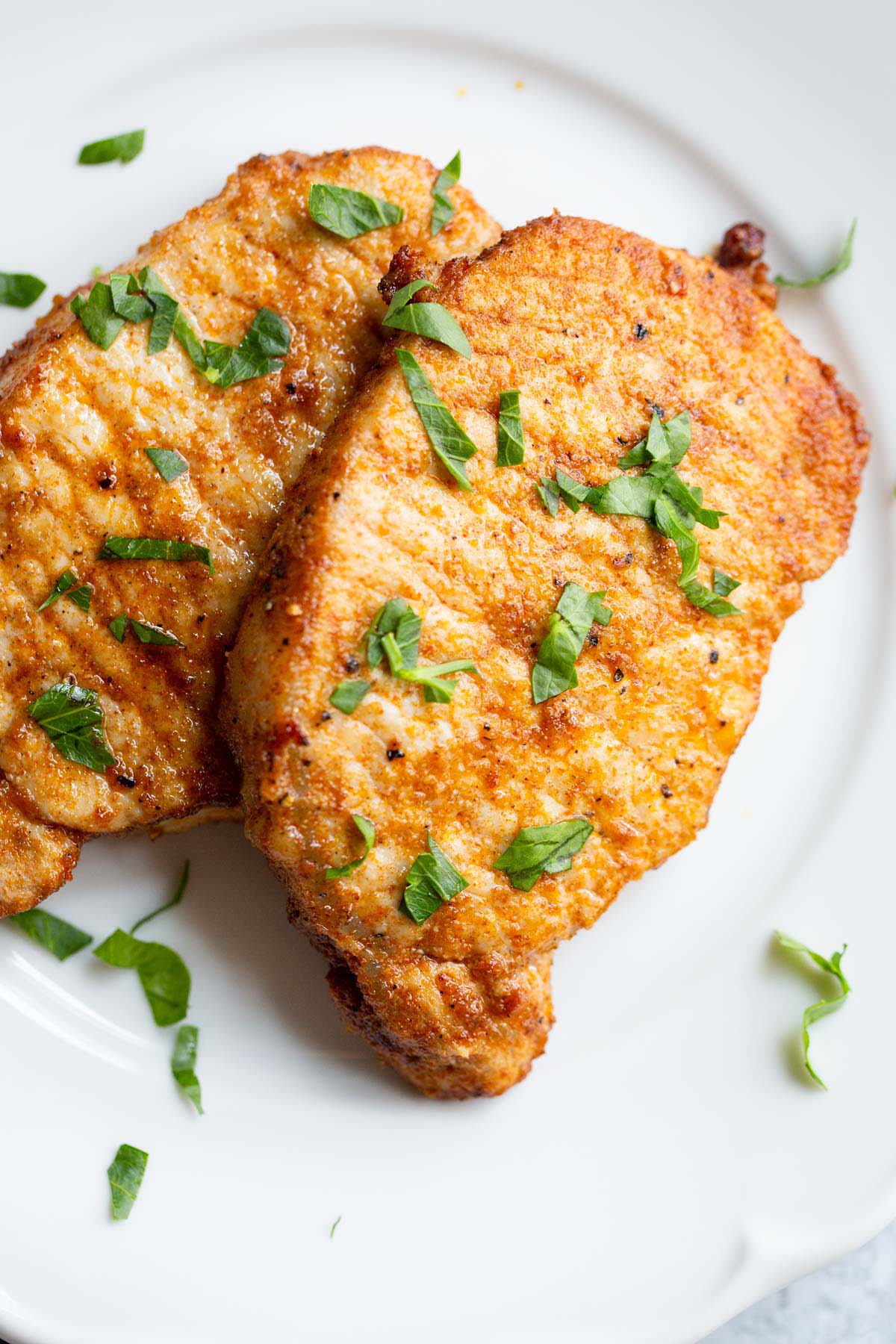 Two pork chops on a plate.