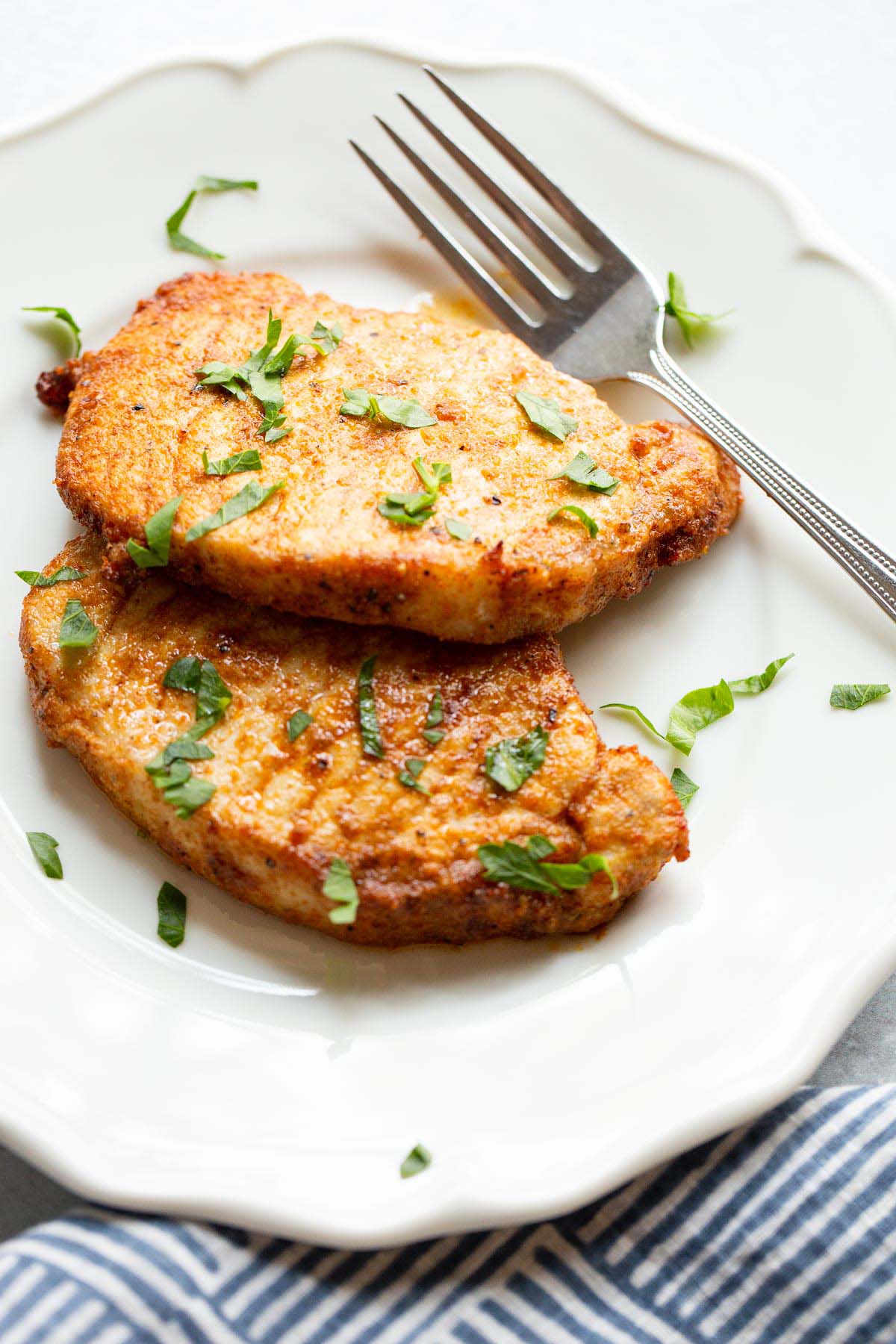 Two pork chops on a plate.