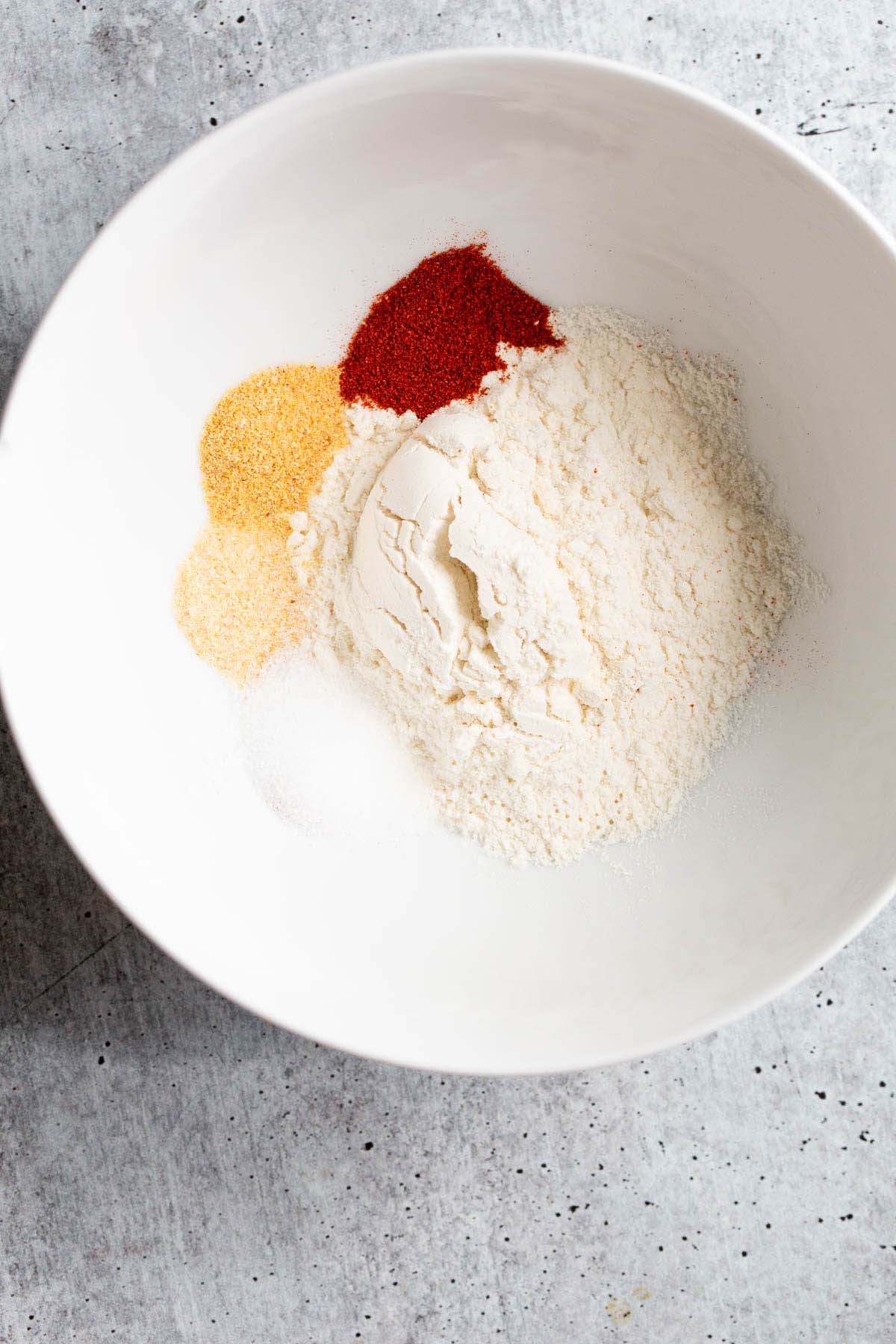 flour and other seasonings in a white bowl