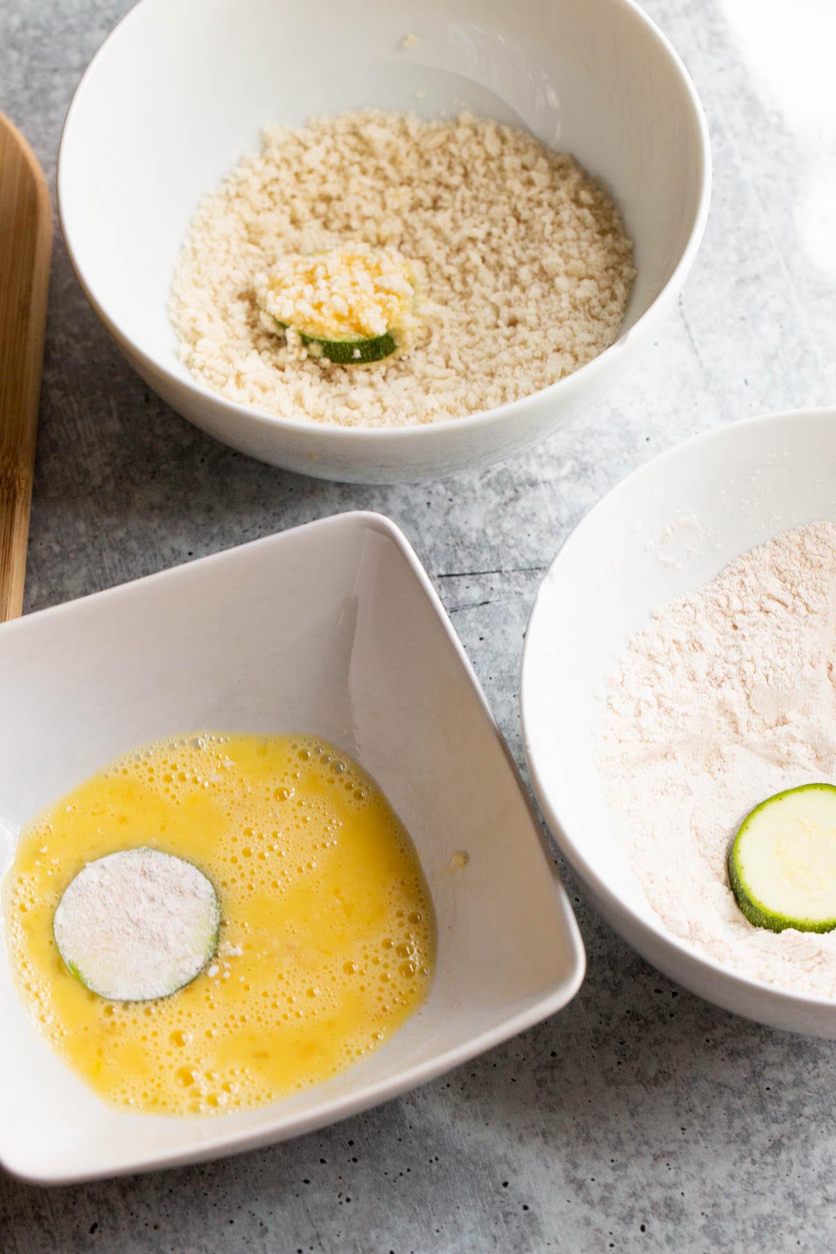 dipping zucchini in flour, egg, and panko