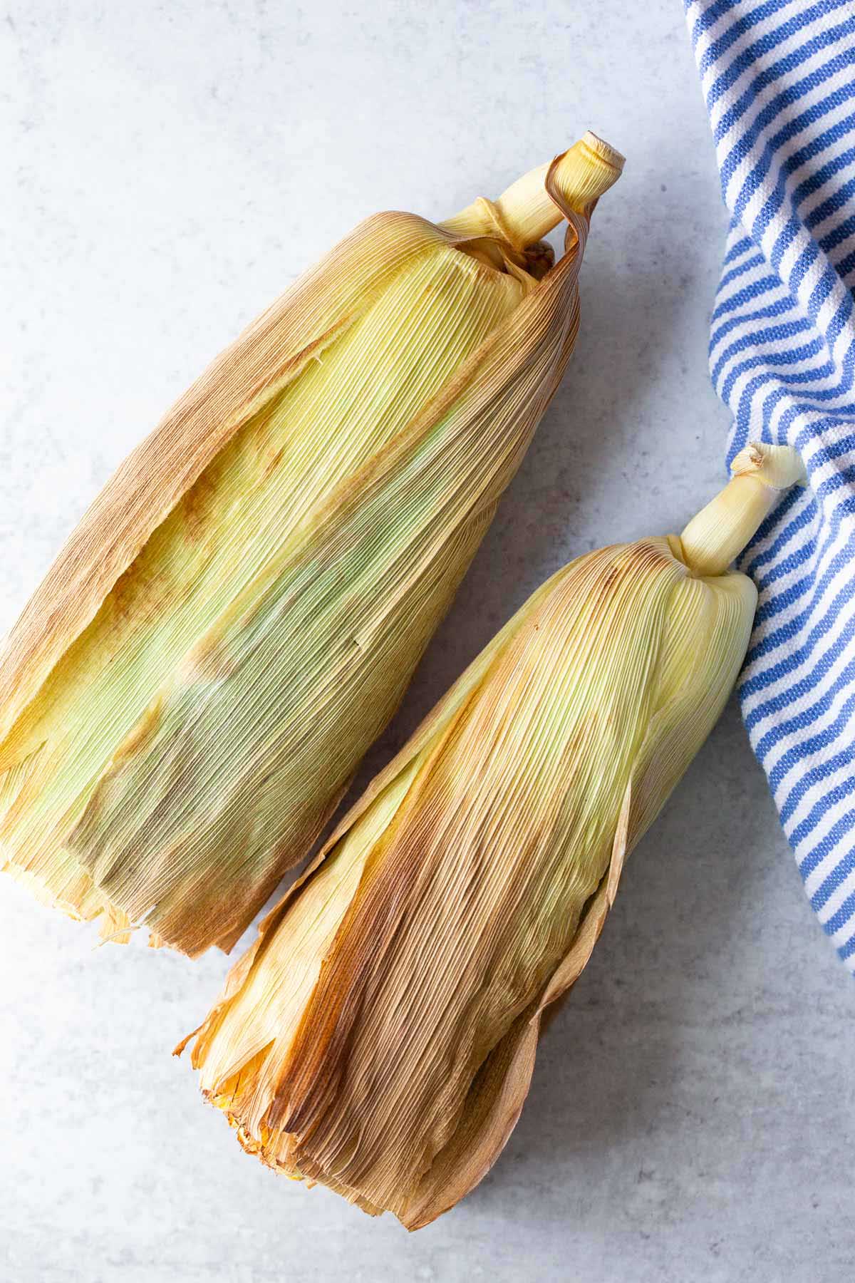 Air fried corn on the cob in a husk.