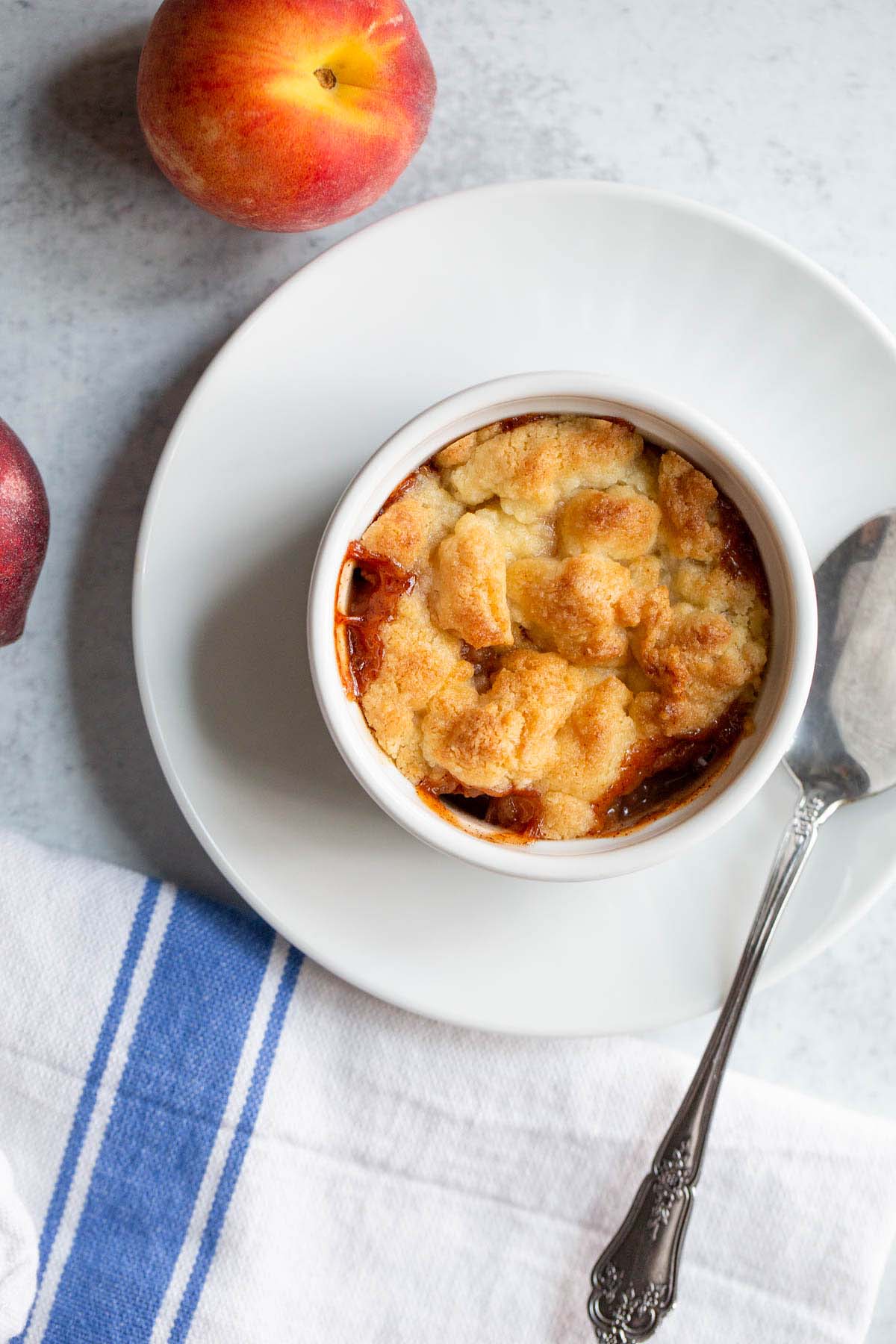 Peach cobbler in a ramekin from above.