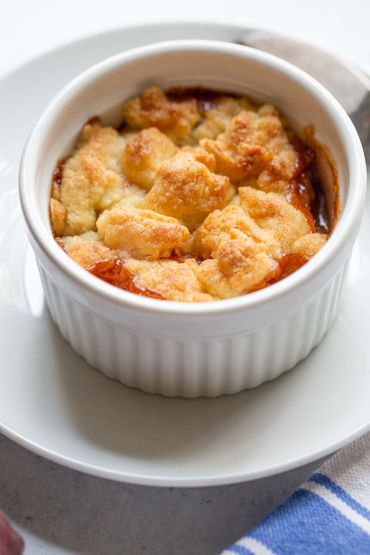 Peach cobbler in a ramekin.