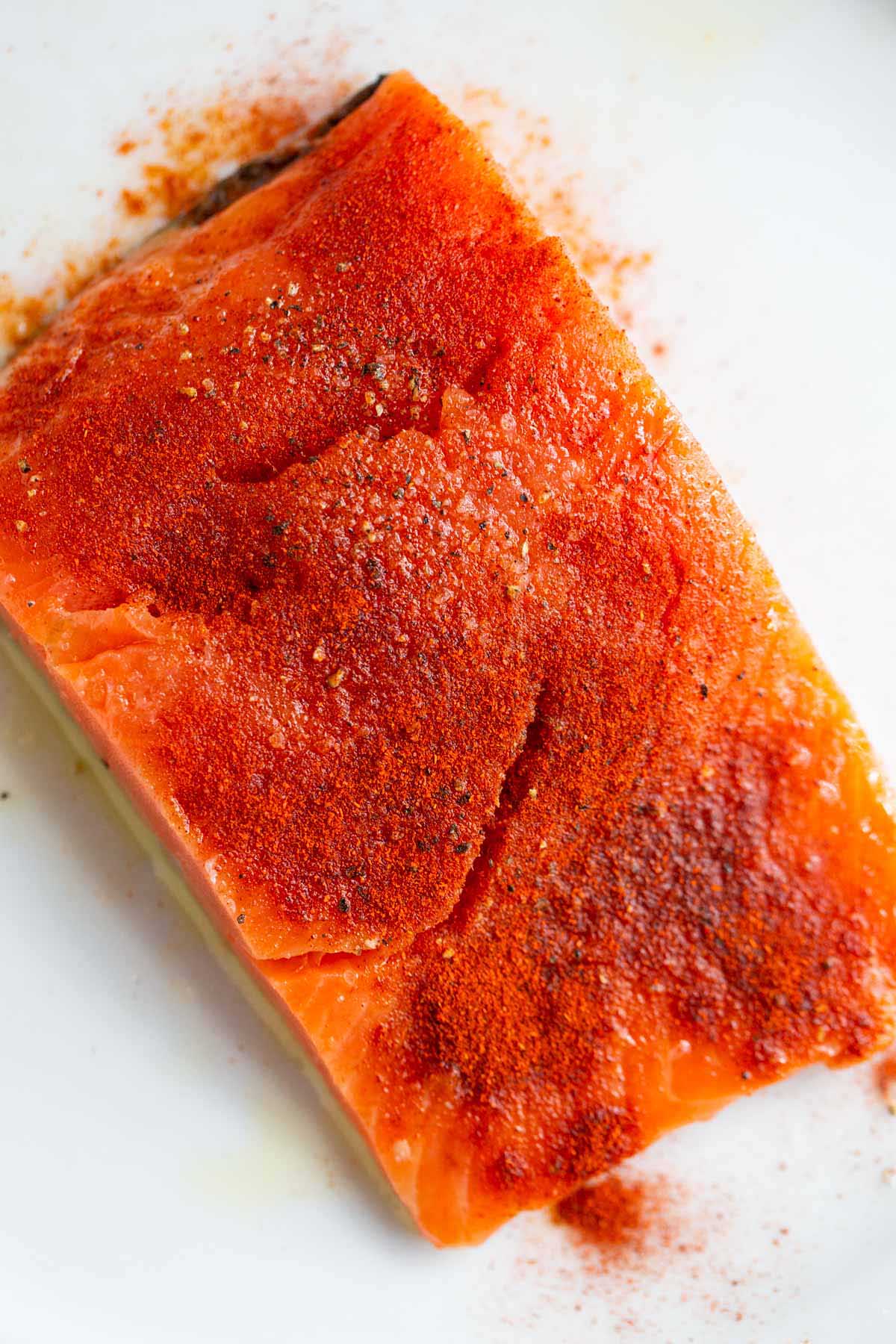 Uncooked salmon with seasoned with smoked paprika.