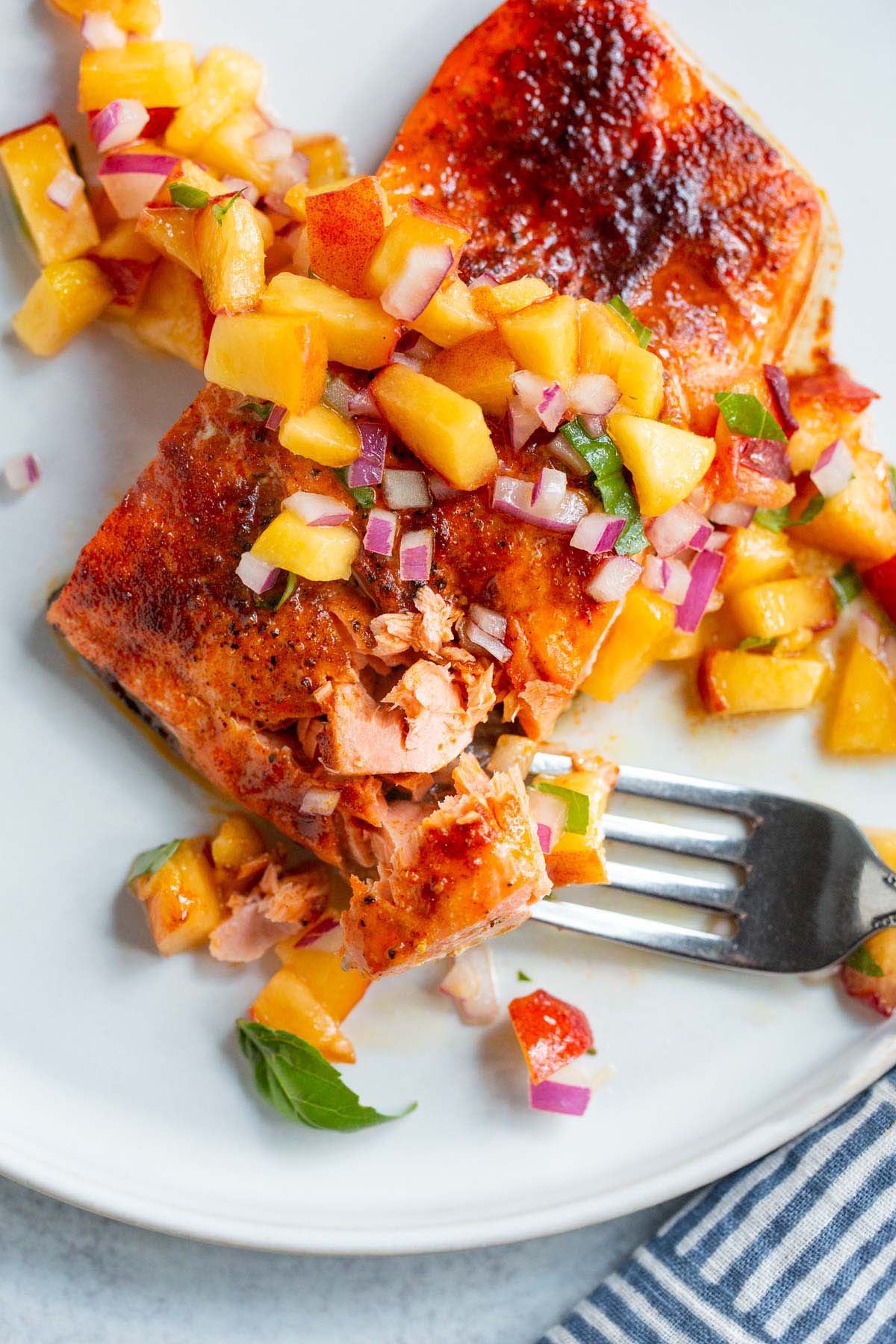 Salmon topped with peach salsa.