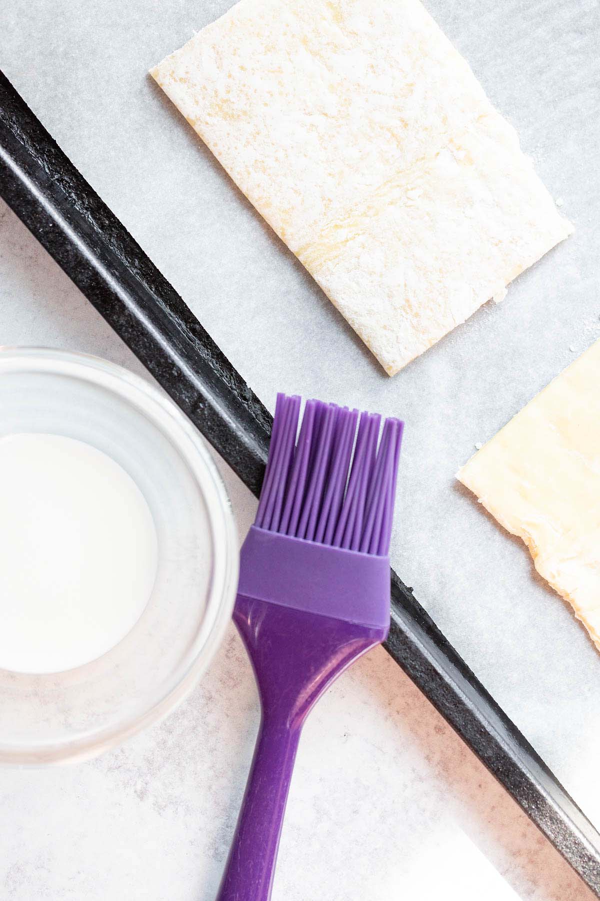 Uncooked puff pastry rectangles.