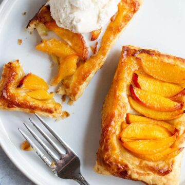 Peach puff pastry tart with ice cream.