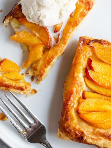 Peach puff pastry tart with ice cream.