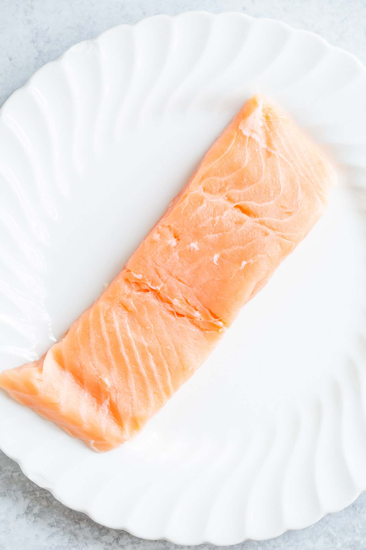 Uncooked salmon on a plate.