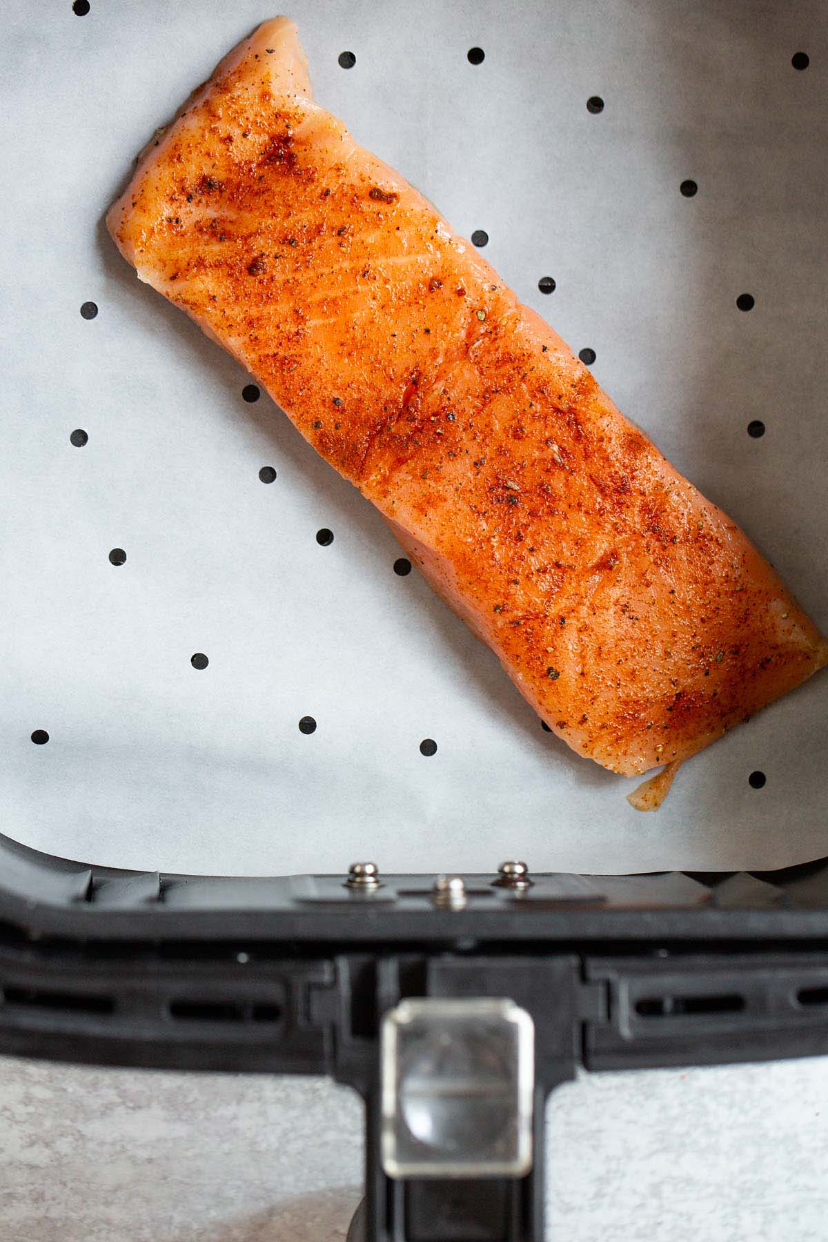 Uncooked salmon in air fryer.