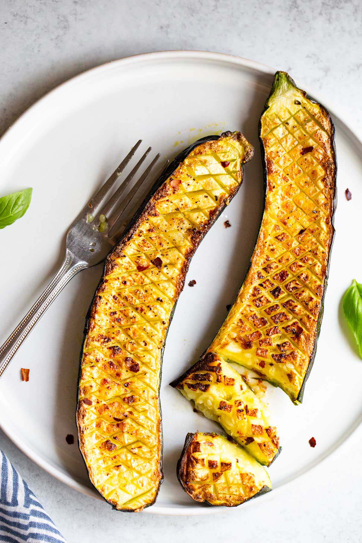 Crisscross zucchini cut with a fork.