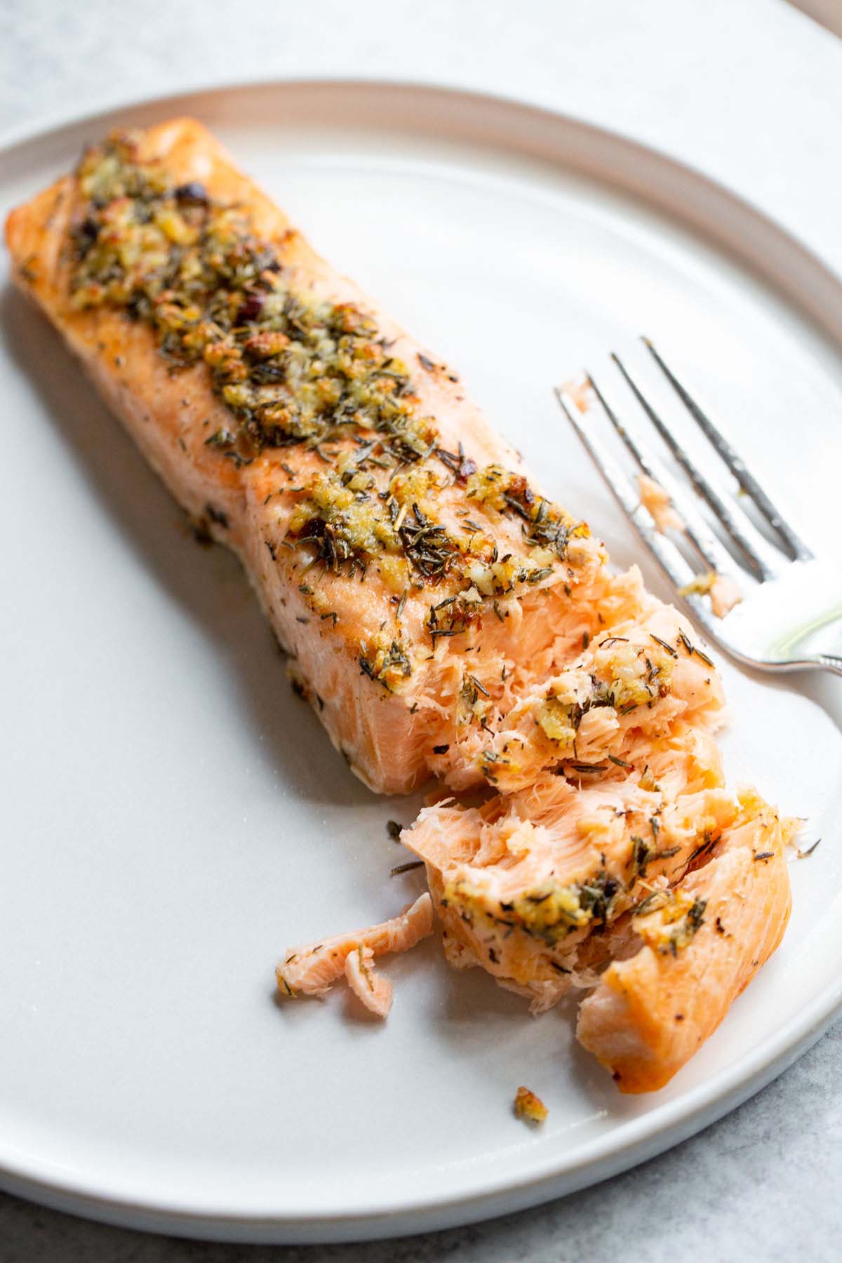 Salmon on a white plate with a fork.