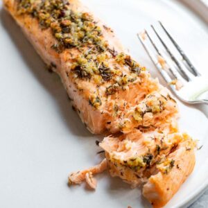 Garlic butter salmon on a plate.