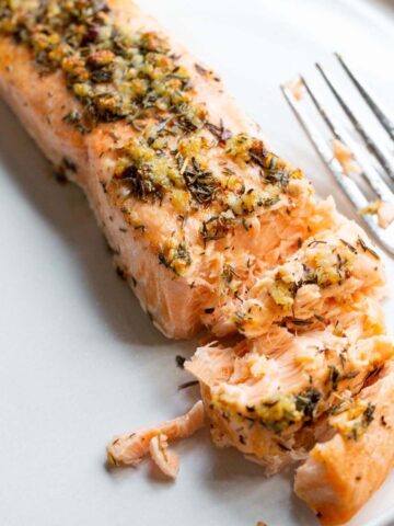 Garlic butter salmon on a plate.