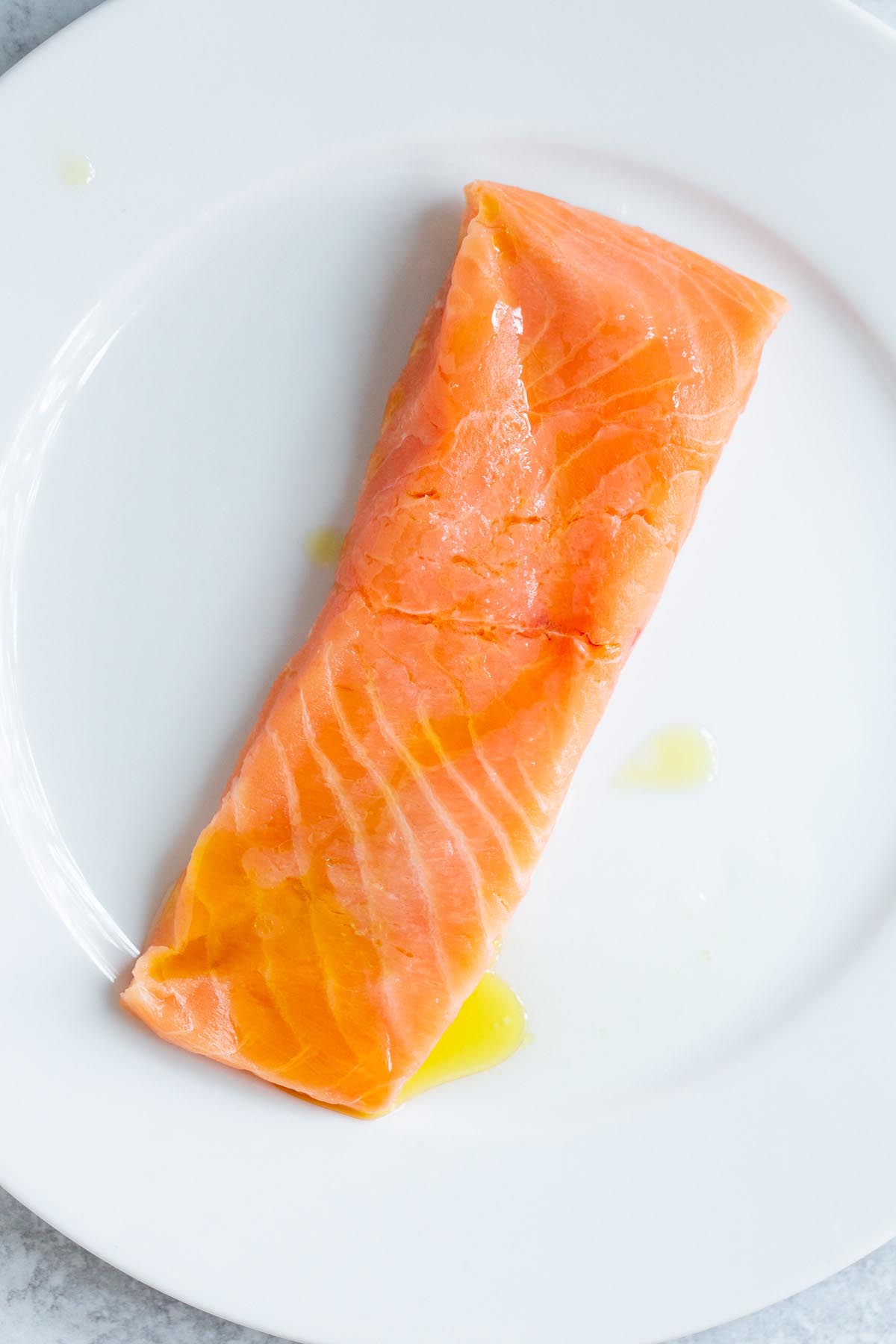 Uncooked salmon with lemon juice and olive oil.