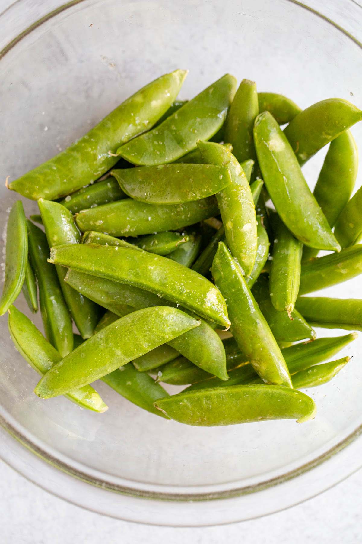 Raw snap peas in a bowl.