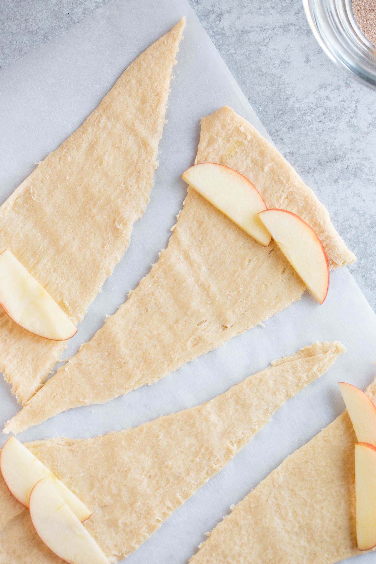 Adding apple slices to crescent rolls