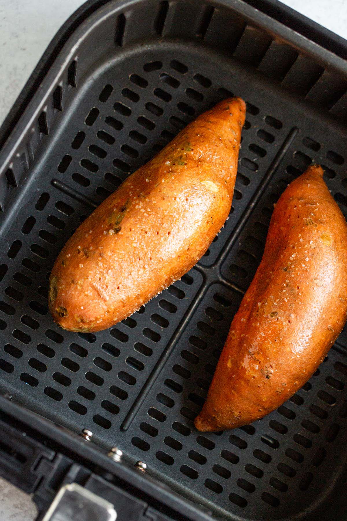 Sweet potato in air fryer basket.