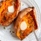Baked sweet potato with butter and parsley.