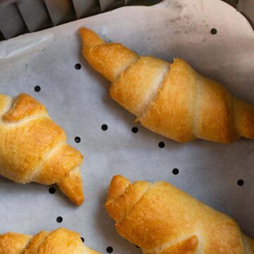 Crescent rolls in air fryer basket.