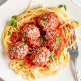 Air fried meatballs with tomato sauce over spaghetti.