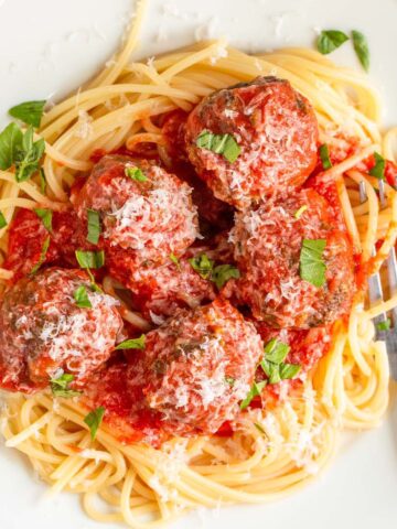 Air fried meatballs with tomato sauce over spaghetti.