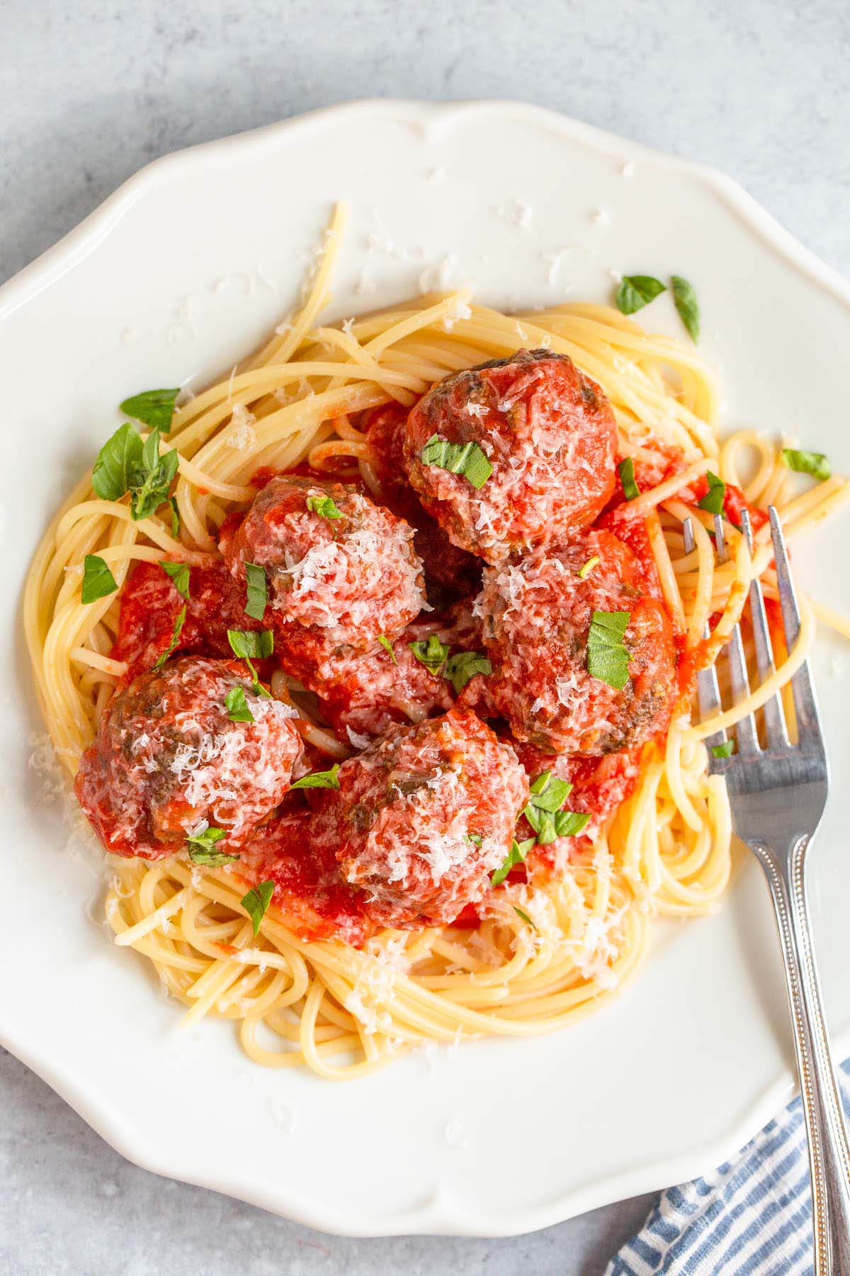 Air fried meatballs with tomato sauce over spaghetti.