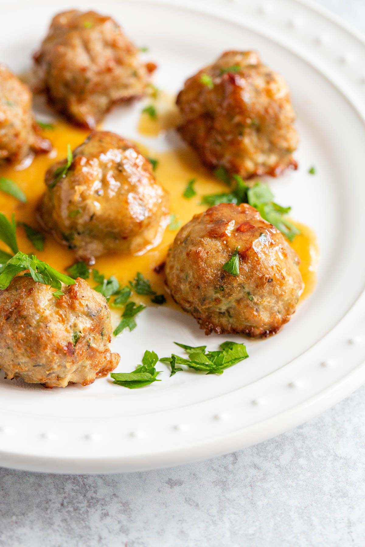 Air fried turkey meatballs with parsley up close.