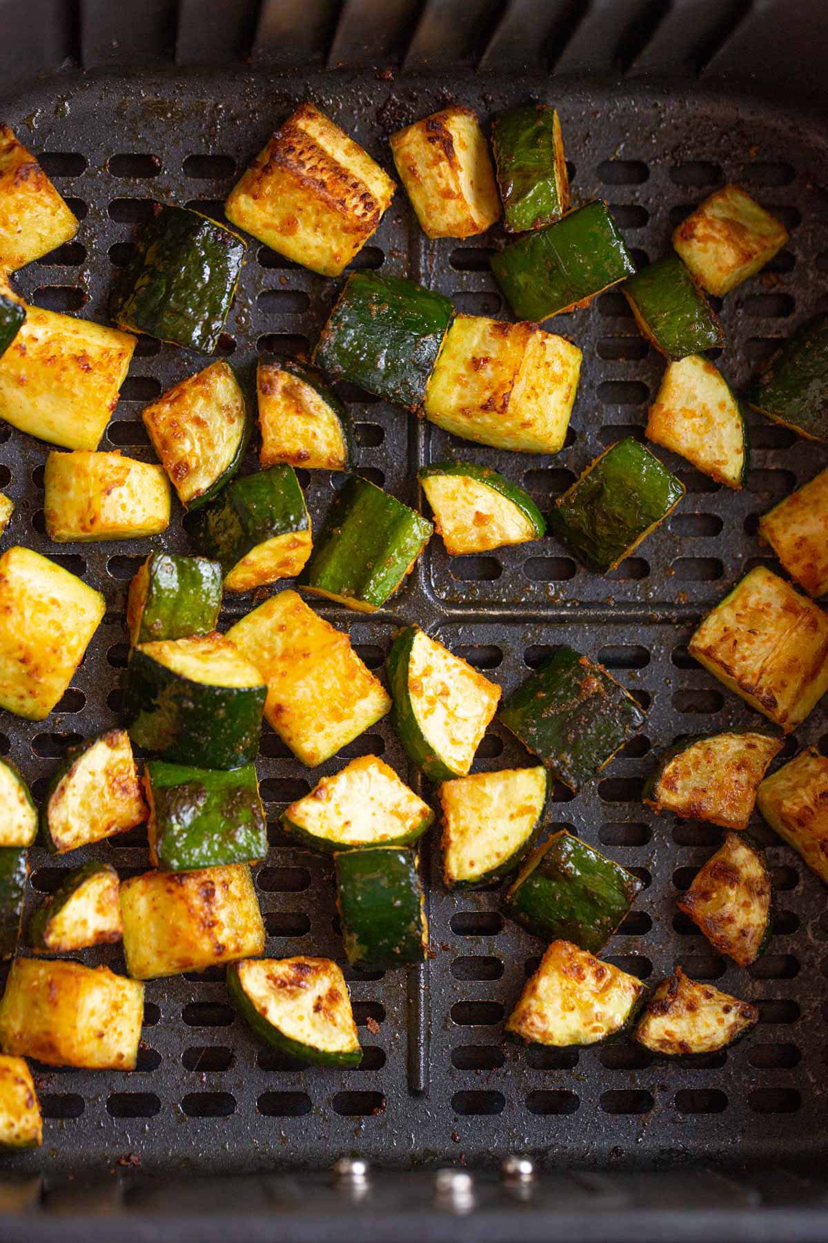 Cooked zucchini in air fryer basket