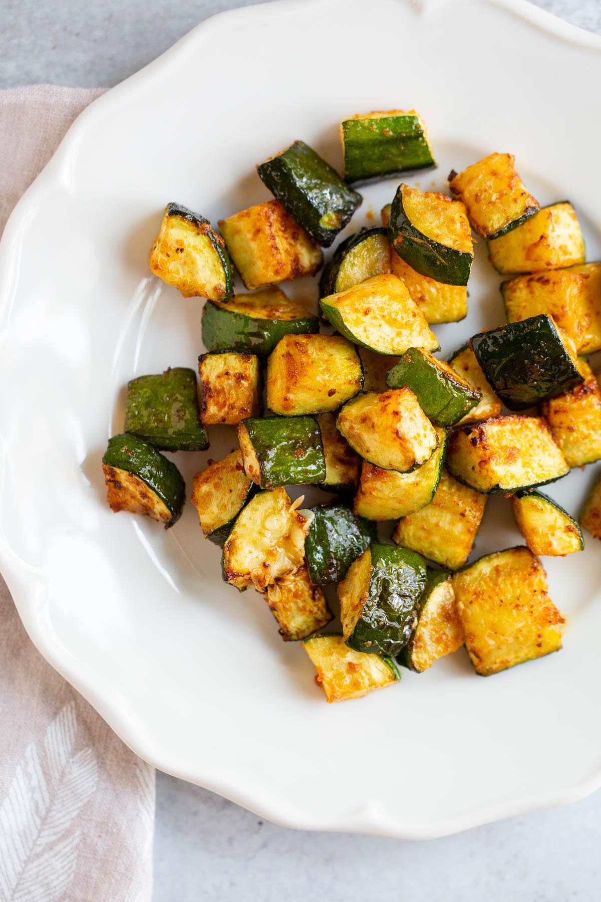 Air fryer zucchini on a white plate.