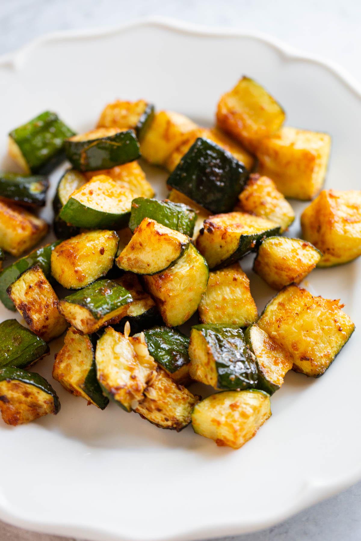 Air fryer zucchini on a white plate.