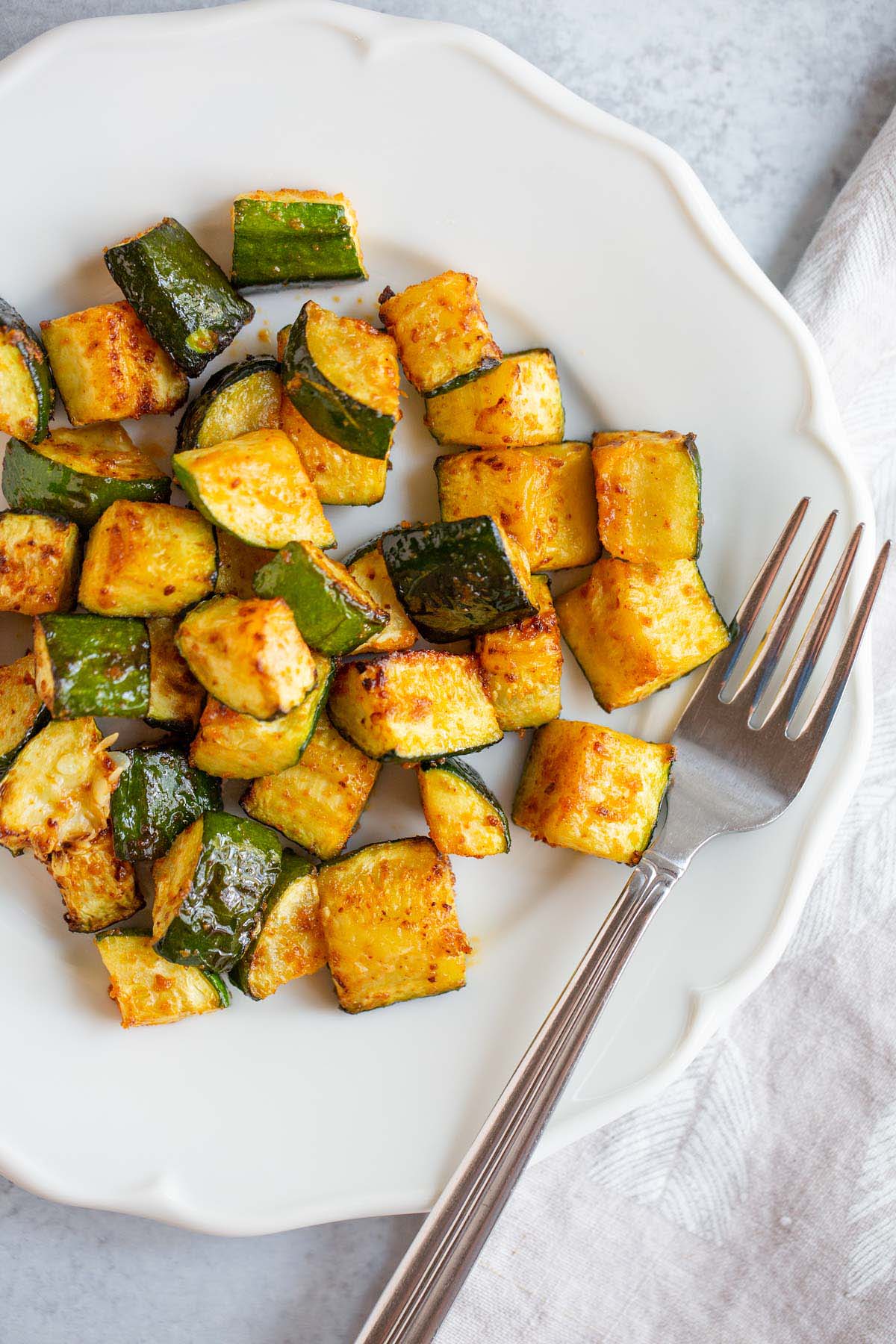 Air fryer zucchini on a white plate.