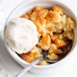 Air fryer apple cobbler with a scoop of ice cream on top.