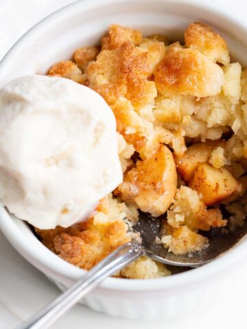 Air fryer apple cobbler with a scoop of ice cream on top.