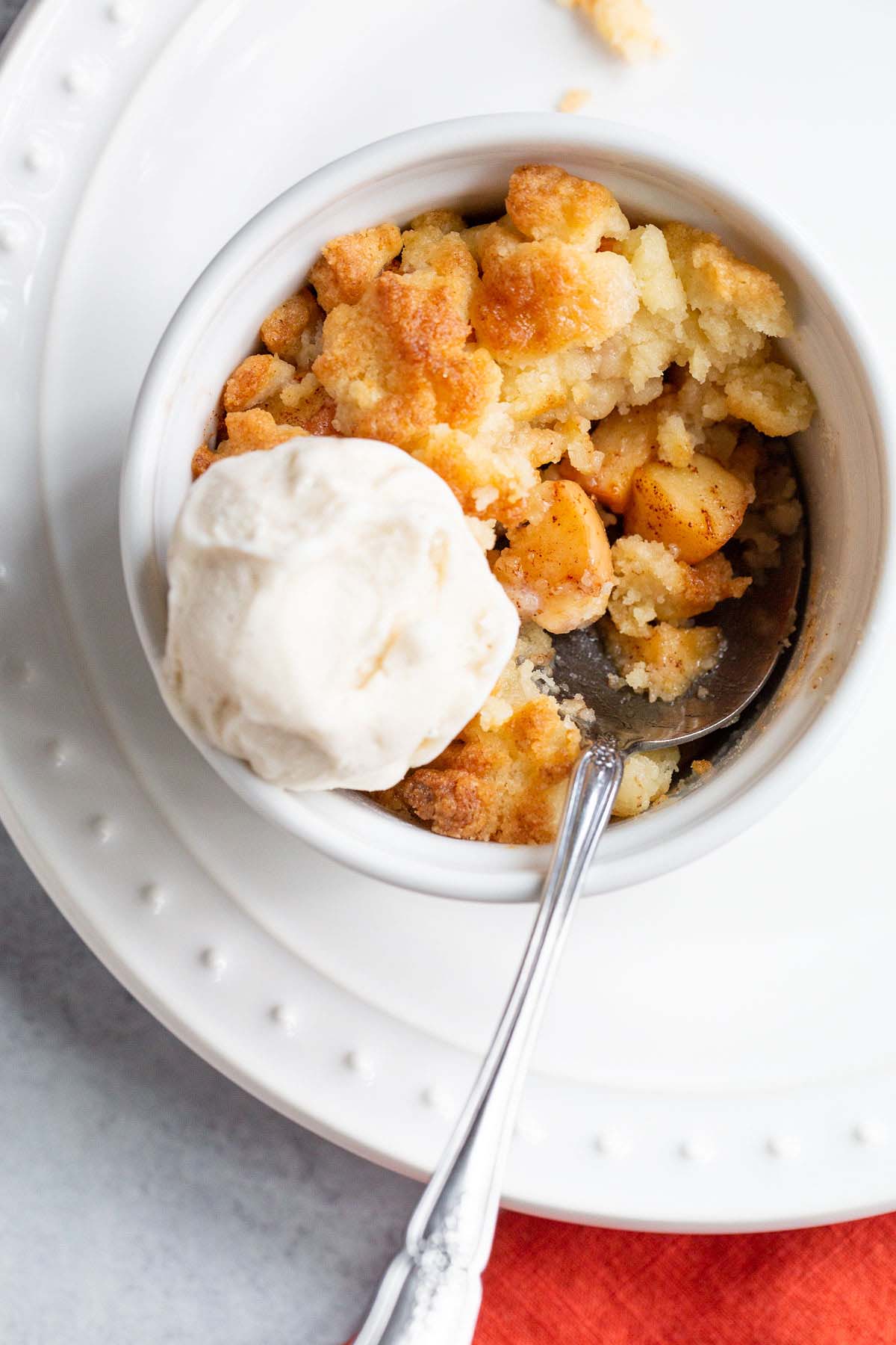 Air fryer apple cobbler with a scoop of ice cream on top.