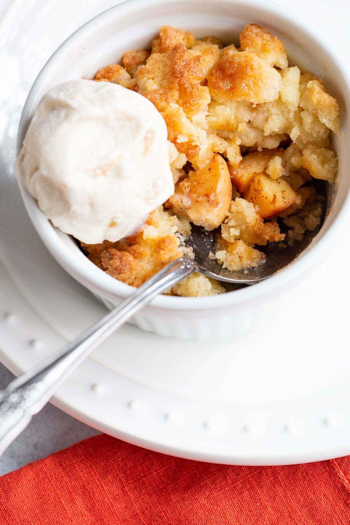 Air fryer apple cobbler with a scoop of ice cream on top.