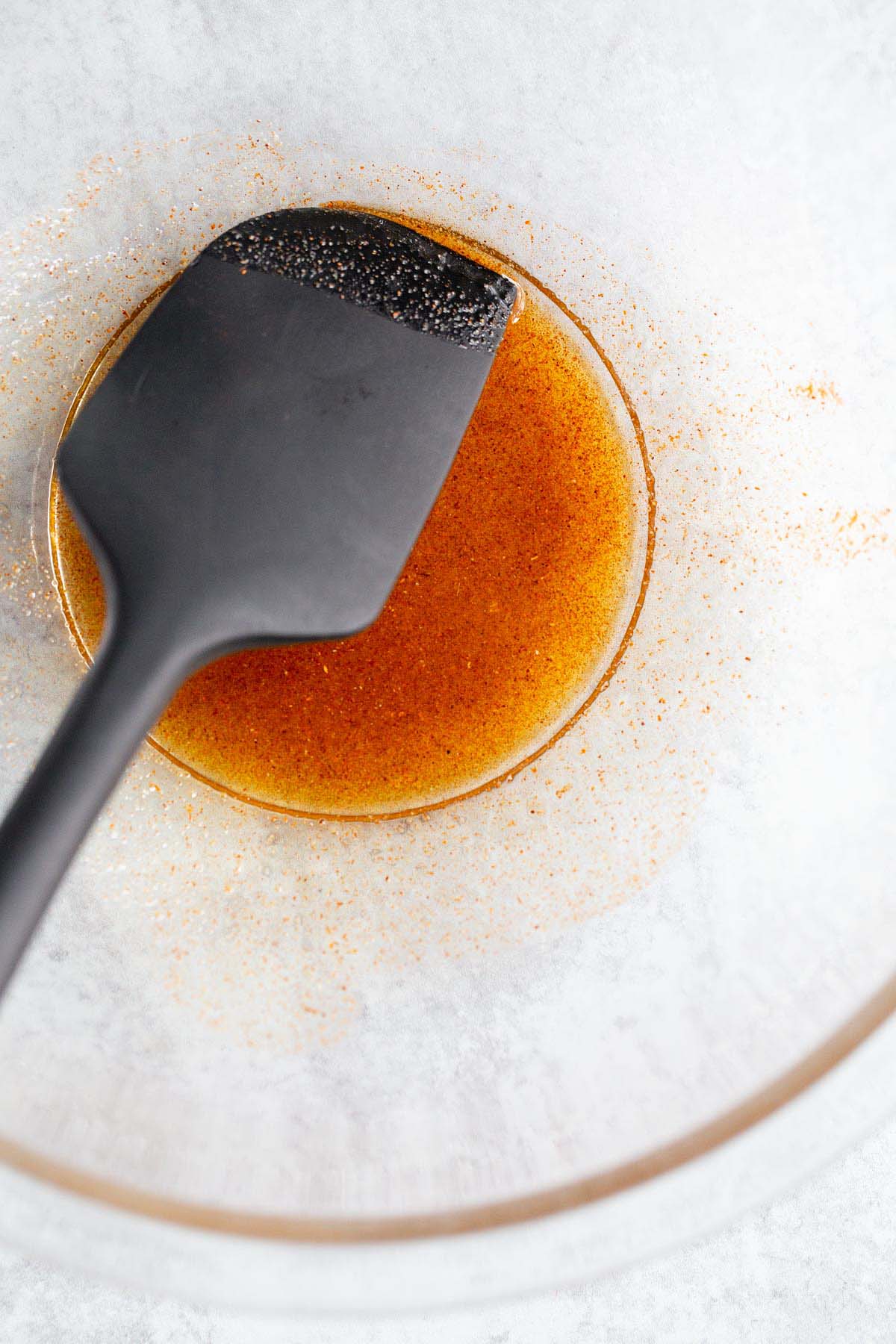 Oil and seasonings mixed in a bowl.