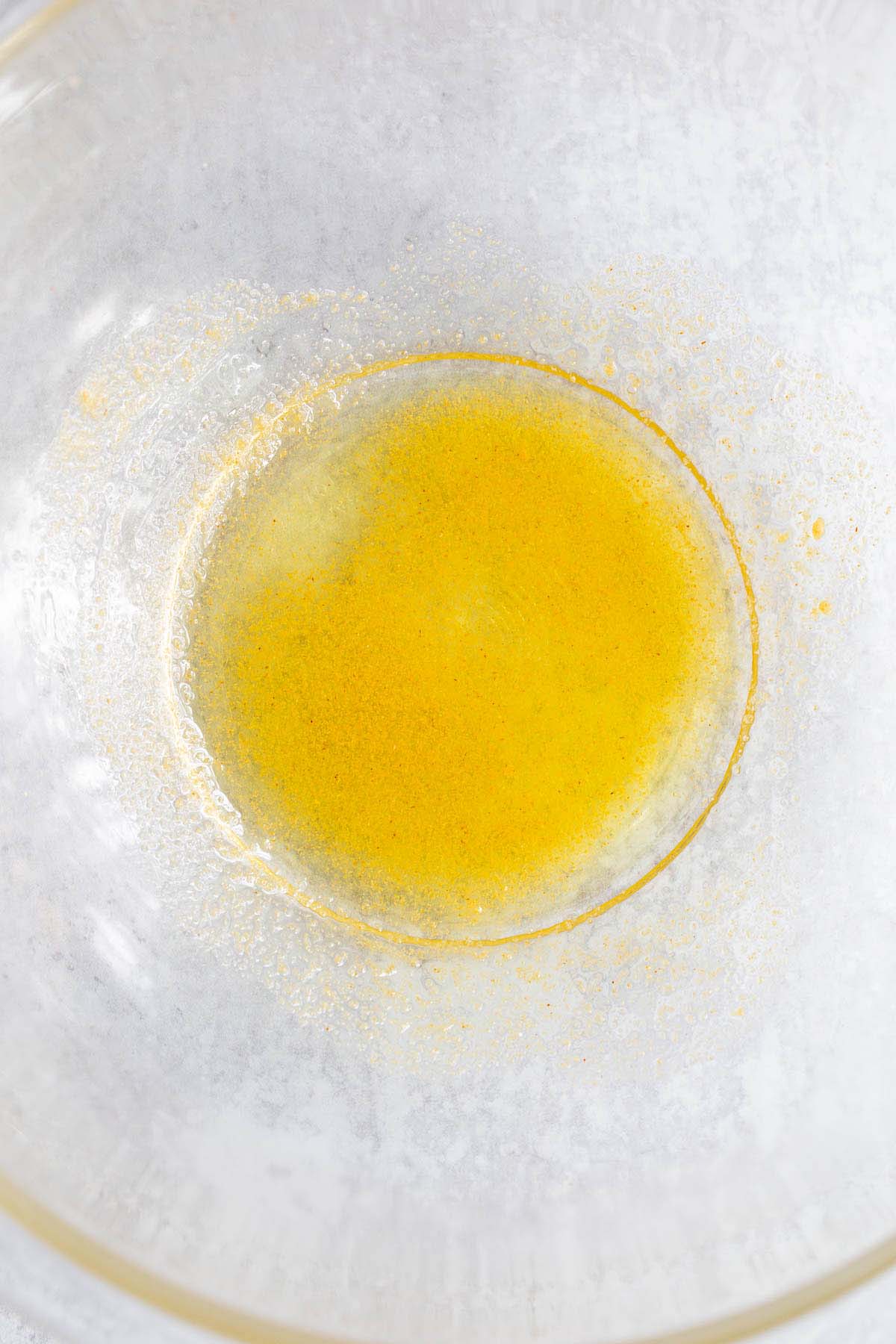 Oil and seasonings in a bowl.