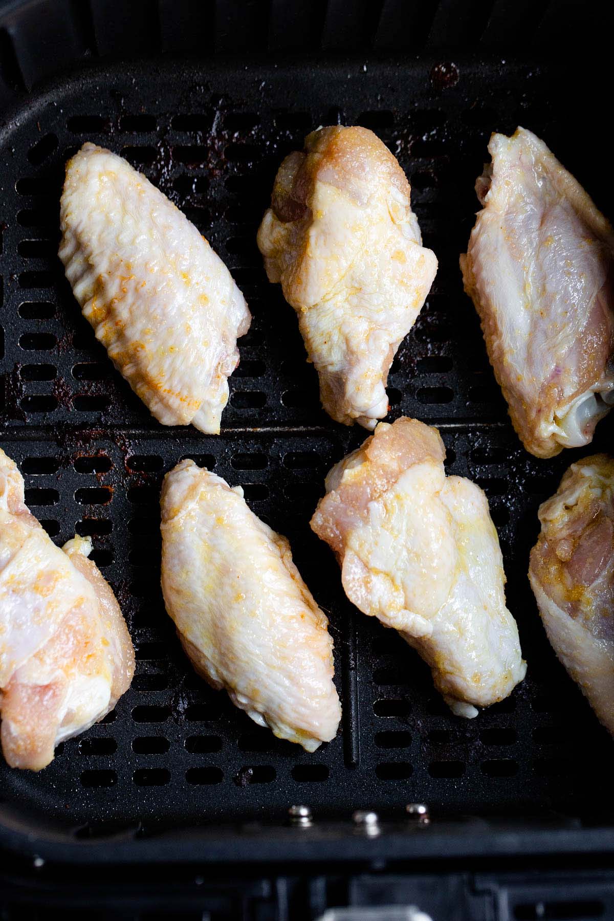 Raw chicken wings in air fryer.