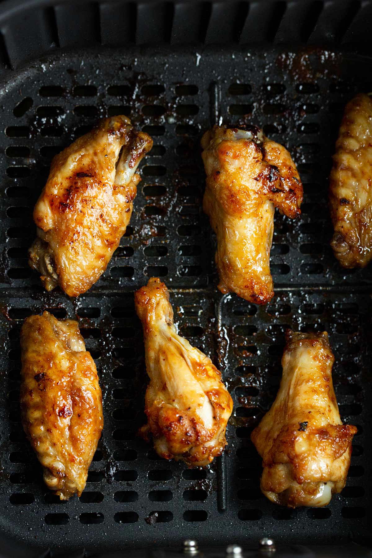 Cooked chicken wings in air fryer.