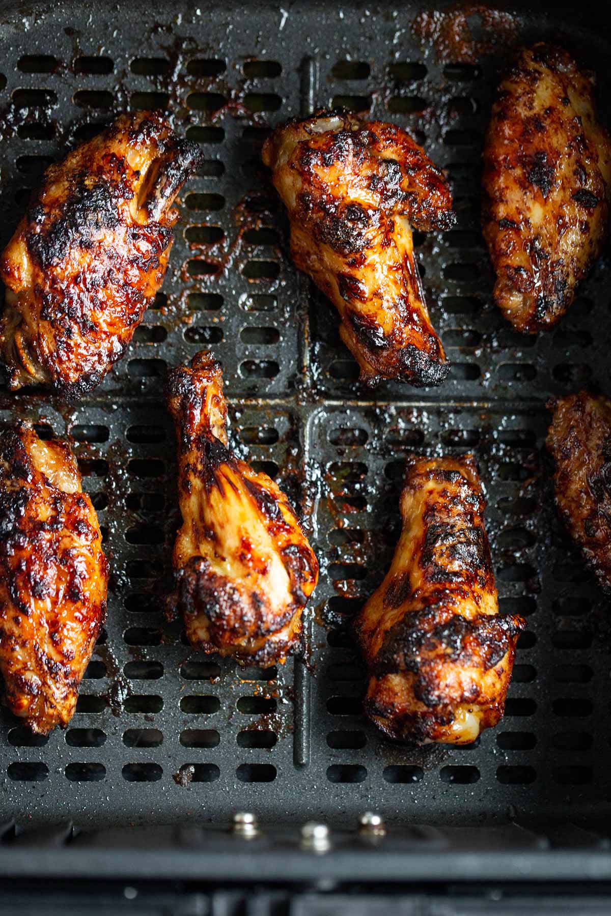 Air fryer honey garlic wings in air fryer basket.