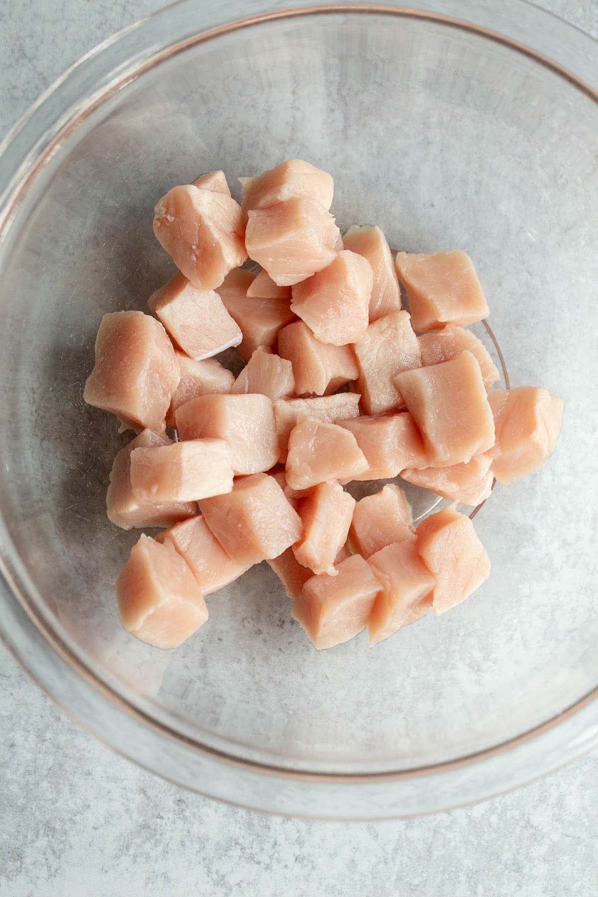 Raw cubed pork in a bowl.