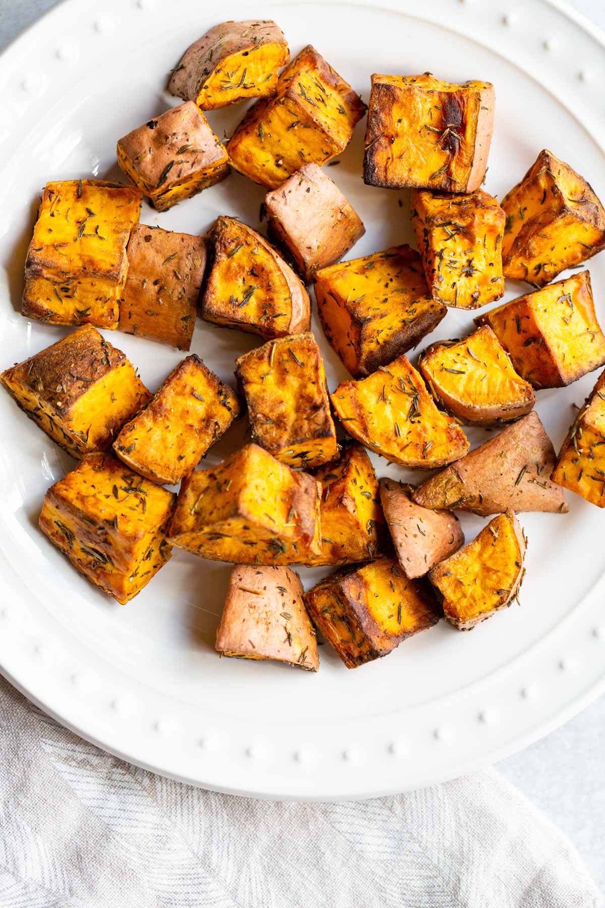 Air fried sweet potatoes on a white plate.