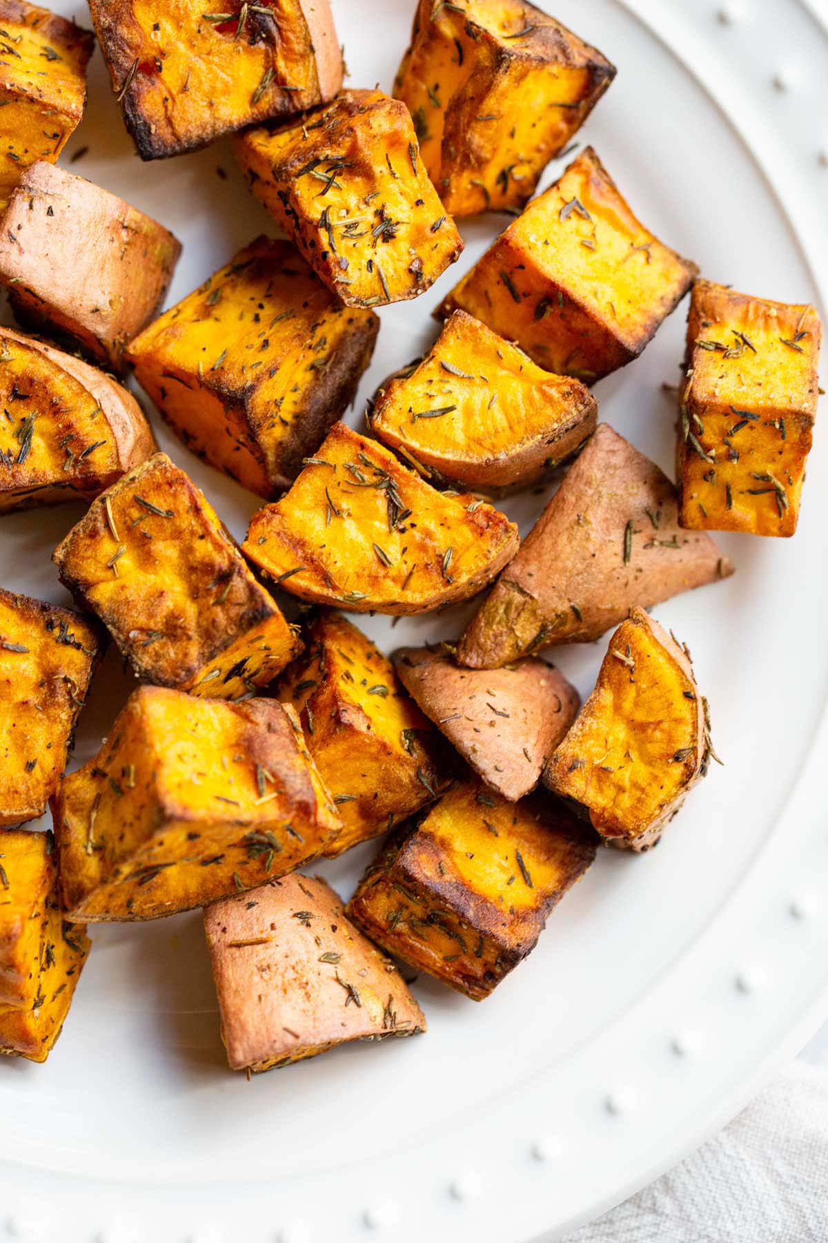 Air fried sweet potatoes on a white plate.